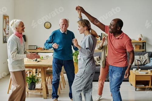 Preview: Senior people dancing with their caregiver