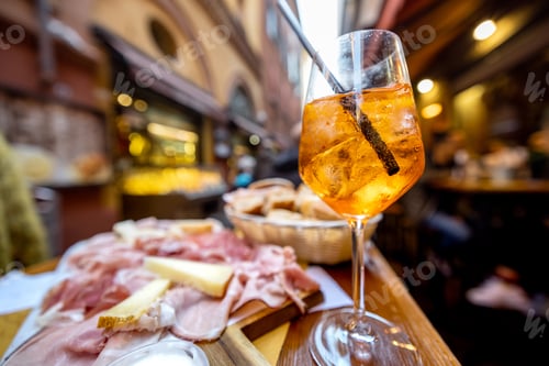 Preview: Italian meat plate and drink on table at outdoor bar