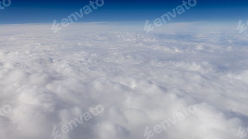 Preview: The beautiful cloudscape with clear blue sky. A view from airplane window.