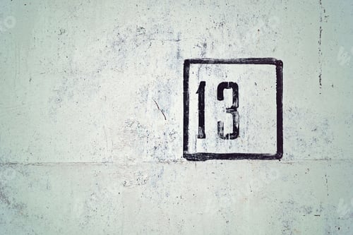 Preview: Number 13 painted on white house wall