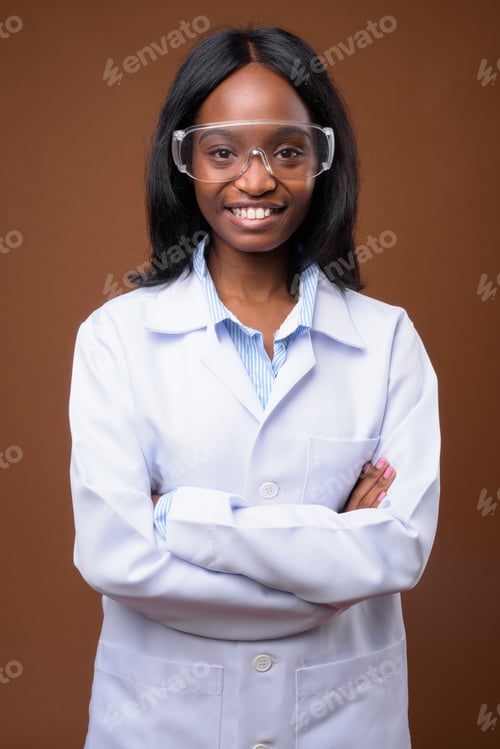Preview: Young beautiful African Zulu woman doctor wearing protective gla