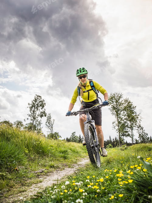 Preview: Woman mountain biking, Augsburg, Bavaria, Germany