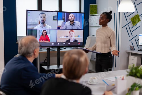 Preview: Black manager woman talking with remotely colleagues on
