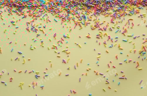 Preview: Colorful Sprinkles Scattered on Yellow Background for Dessert