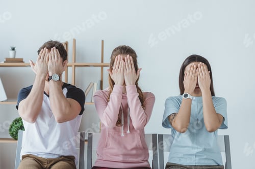 Preview: young students closing faces with hands