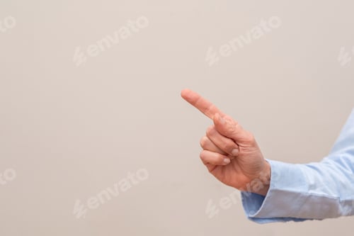 Preview: close up of Hand pointing index finger to the side on a neutral background with copy space