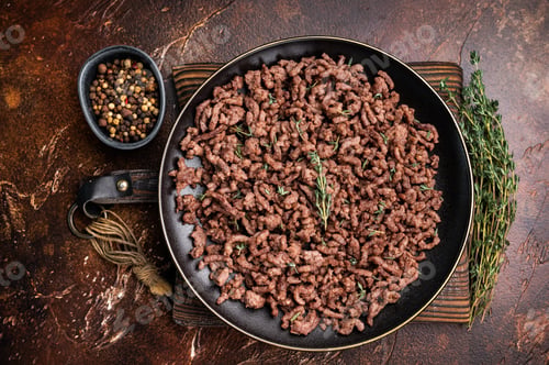 Preview: Fried mincemeat, cooked forcemeat in a plate. brown background. top view