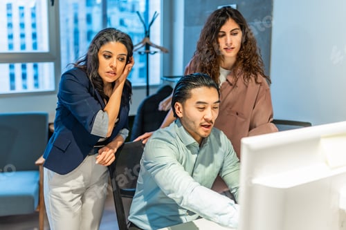 Preview: Business team analyzing data on computer in modern office