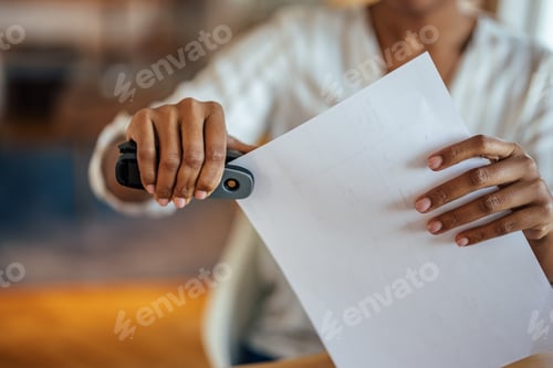 Preview: Picture of a woman, putting documents together.