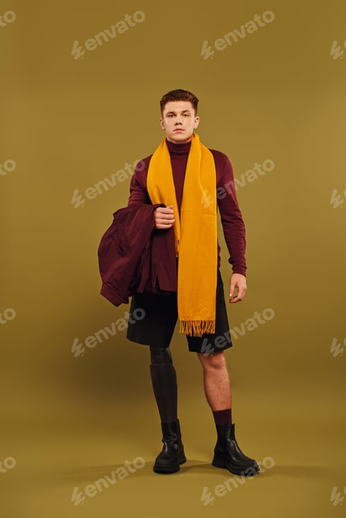 Preview: A young man confidently poses in fashionable attire, highlighting his prosthetic leg