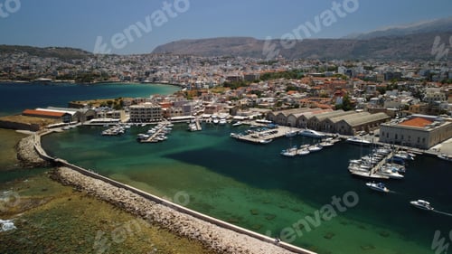 Preview: Aerial view of a harbor with several boats moored in the tranquil blue waters