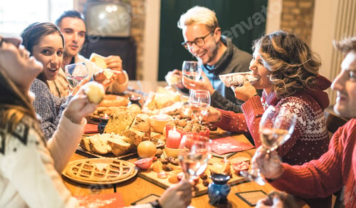 Preview: Friends tasting christmas food and having fun at home drinking champagne sparkling wine