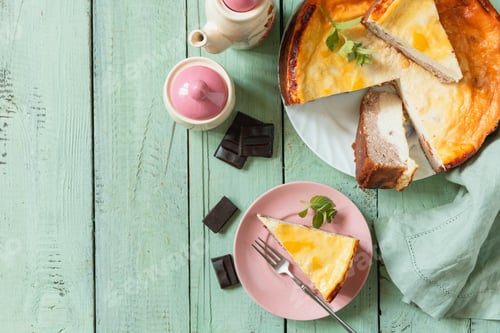 Preview: Delicious lemon cheesecake with tea set for dessert presentation. Top view