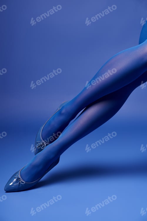 Preview: Ethereal elegance: a young womans legs in blue tights