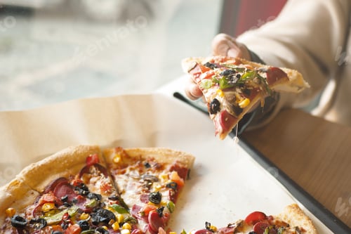 Preview: Enjoying a slice of delicious pizza at a cozy restaurant