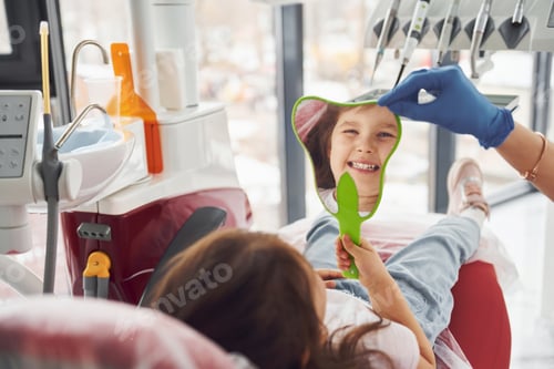 Preview: Looks into the mirror. Little girl visiting dentist in clinic. Conception of stomatology
