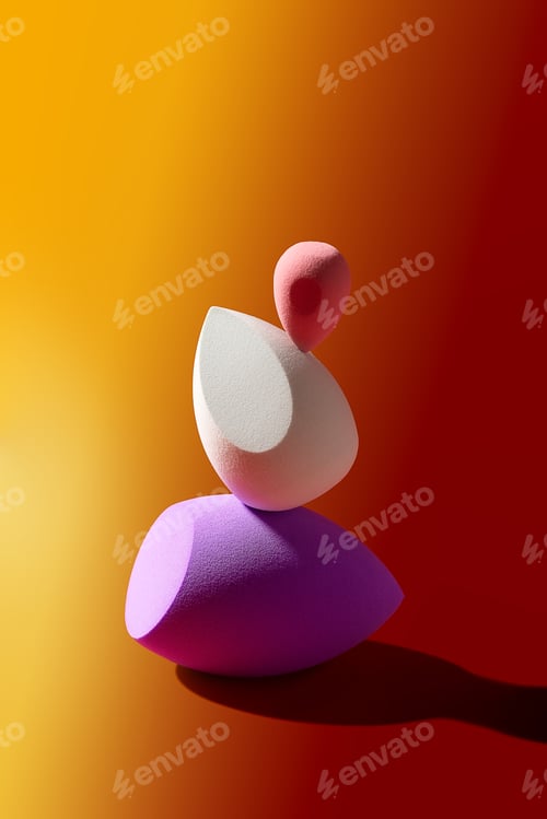 Preview: Three colorful makeup sponges are carefully stacked on top of each other