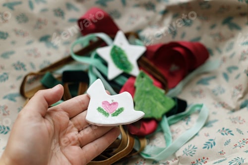 Preview: Christmas ornaments. Hand holding stylish handmade clay horse on background