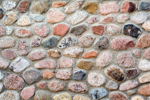 Preview: Flat detail view of a wall made from different stones. Abstract stone background