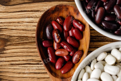 Preview: dried beans in wooden spoons on the table