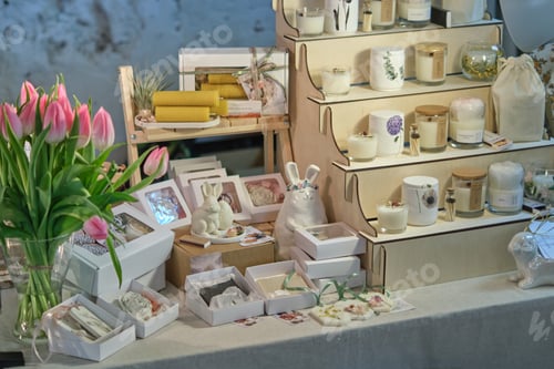 Preview: beautiful market stall filled with handcrafted items at a seasonal fair. Springtime events and