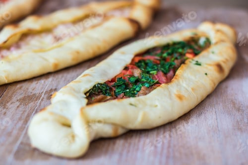 Preview: Closeup shot of delicious flatbread pockets with different fillings
