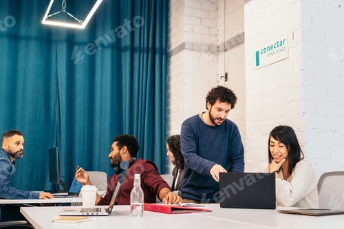 Preview: Group of multiracial people working with laptop in a coworking