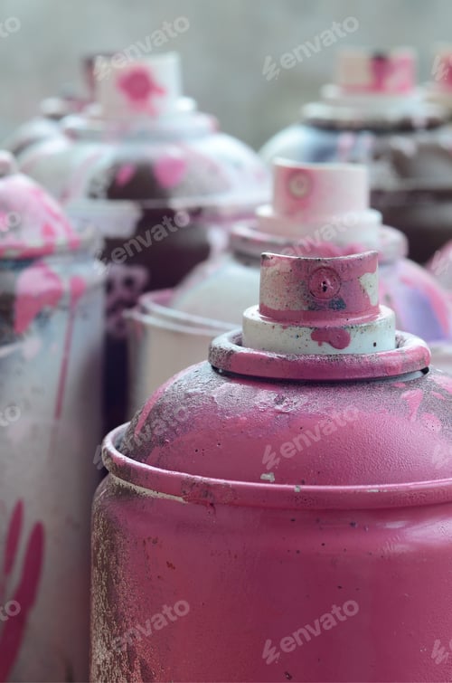 Preview: A lot of dirty and used aerosol cans of bright pink paint