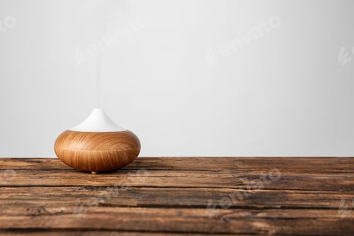 Preview: Aroma oil diffuser lamp on table against light background