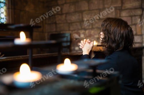 Preview: Young boy praying in a church