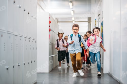 Preview: cute funny pupils running through school corridor