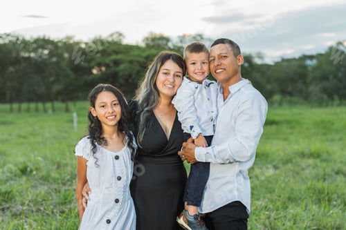 Preview: latin family, together posing happily smiling as they stroll through the countryside.