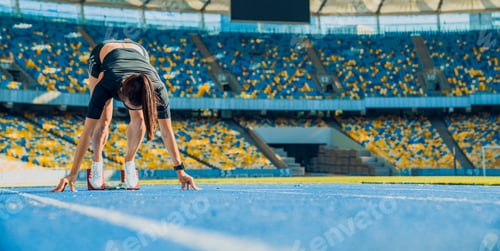 Preview: Female athlete taking position on her marks to start off the run