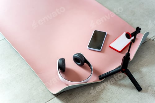 Preview: Yoga mat with headphones and phone. Sport at home.
