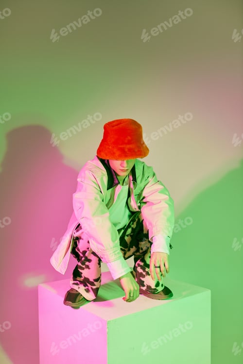 Preview: Young man showcases modern fashion in a vibrant urban setting with striking colors