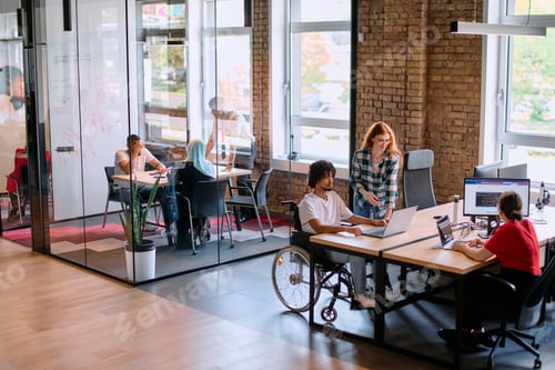 Preview: A diverse group of business professionals collaborates in a modern startup coworking center