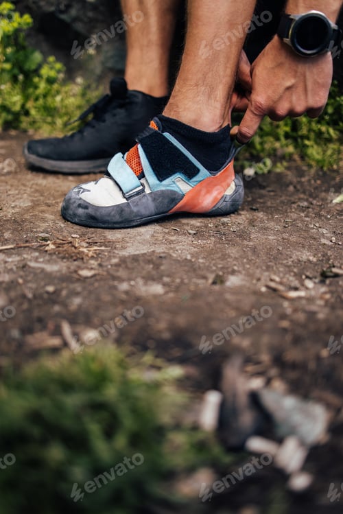 Preview: Climber Adjusting Rock Climbing Shoes Outdoors on Dirt Trail