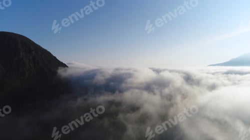 Preview: Beautiful sunrise above the clouds, view from the top of the mountain. Shot. Aerial for slow