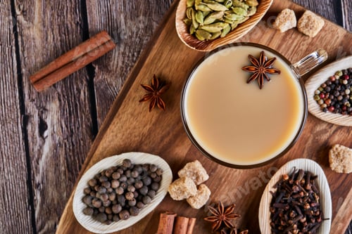 Preview: Traditional Indian drink - masala tea with spices. Cinnamon, cardamom, anise, sugar, cloves, pepper