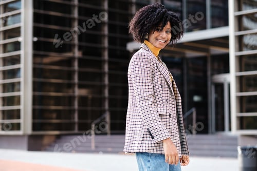 Preview: African American woman walking outdoors.