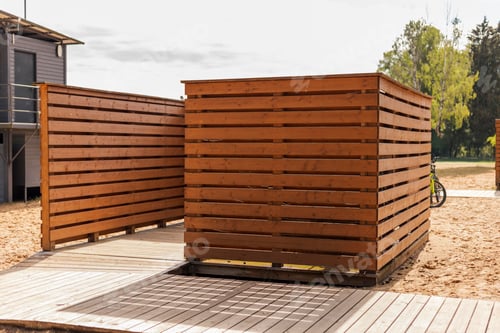 Preview: Wooden changing cabins are situated near the beach, offering a private space for beach visitors