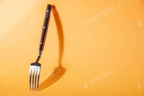 Preview: Close up view of kitchen cutlery set leaning against the wall on the right side on golden