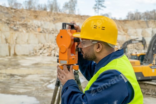Preview: Young surveyor doing engineering work with total station
