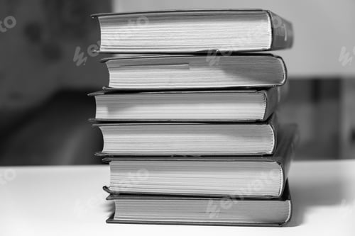 Preview: Stack of books on a white background. One book is yellow.