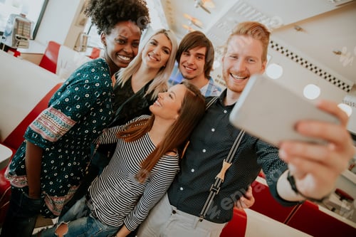 Preview: Group of young people taking selfie with mobile phone