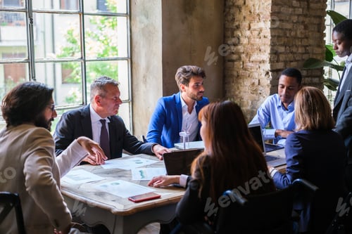 Preview: Workgroup in coworking space talking about renewable energy