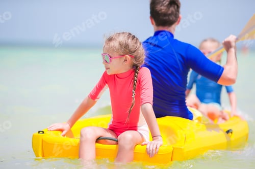 Preview: Little girls and young dad kayaking during summer vacation