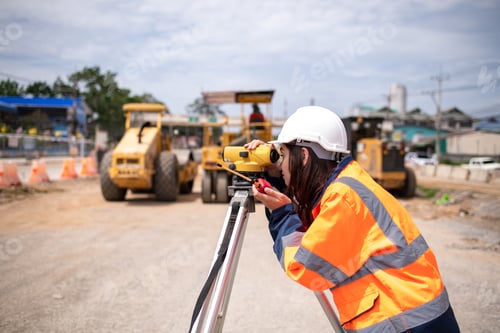 Preview: Engineers Surveyor wearing safety uniform ,helmet with equipment theodolite to measurement positioni