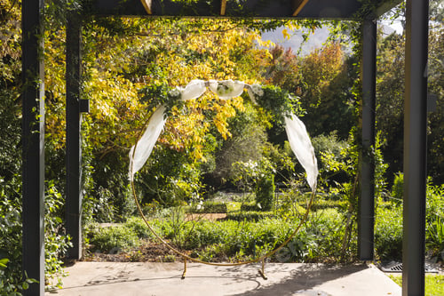 Preview: Wooden arbor and decorative wedding arch garden on sunny day, copy space