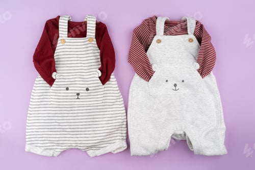 Preview: Baby girl clothes on lilac pastel background